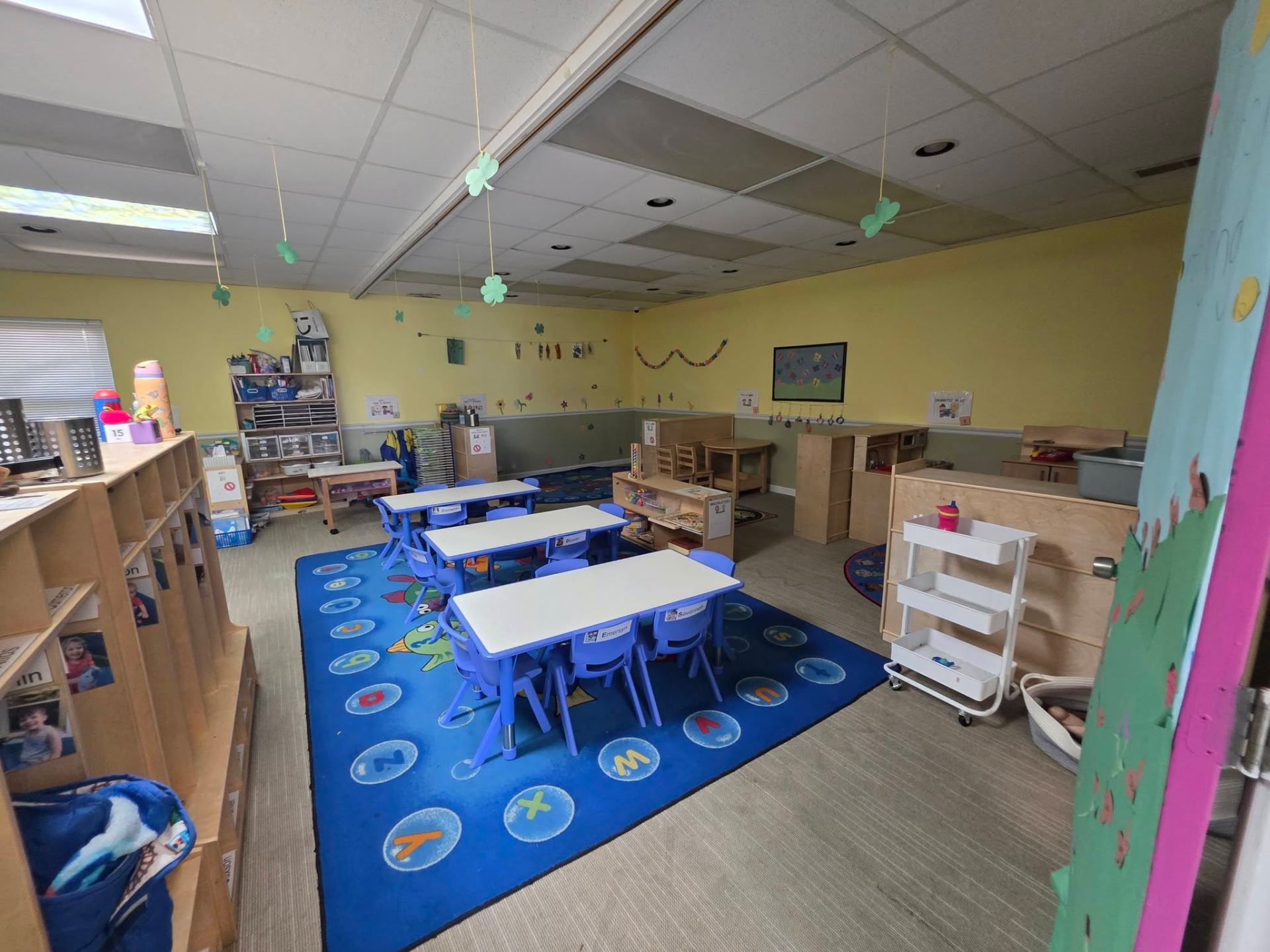 The Butterfly preschool room with tables, decorations, and learning materials